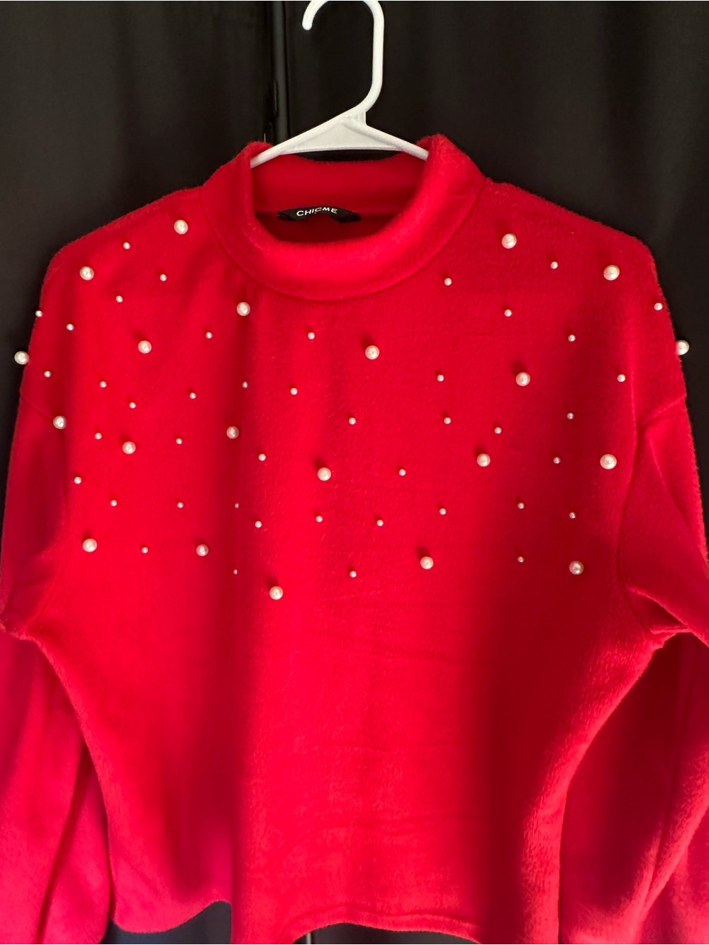 chic red mock neck sweater with pearl accents